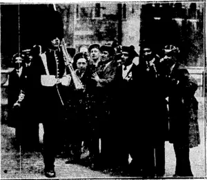Sport and General Tliolo, SCOTTISH "INVADERS."—A few of the 25,000 Scots who visited London on sth April to ivitness the England v. Scotland Rugby football match, barracking the sentry on duty at the Tower of London. (Evening Post, 21 May 1930)