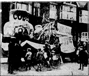 Sport and General, Photo. AT AN ENGLISH BY-ELECTION.—The big^ and little loaf which played a very prominent part in the by-election at West'Fulhamon' 6th May, when Sir Cyril Cobbe regained the seat which he- lost to , , , Labour last year. (Evening Post, 14 June 1930)