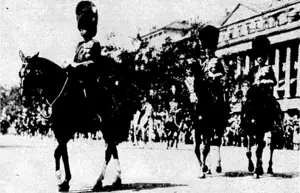 v •-...■■. "Sport and General" Photo. "TROOPING THE COLOUR."—The ceremony of "Trooping the Colour" in celebration of the King's Birthday took place on the Horse Guards Parade, London, on June 3. The Prince of Wales took the salute in place of the King, who was still suffering from rheumatism. At top, the King and Queen, Prince George, the Duchess of York, the Princesses Elizabeth and Margaret Rose, the Princess Royal, Lord Lascelles, the Duke of Connaught (in busby), and other members of the Royal Family on the balcony of Buckingham Palace watching the Prince of Wales take the salute on his return to the Palace from Whitehall. Below, the Prince of Wales, the Duke of York, and the Earl of Harewood on their. • '■■■■■■ ■-■■'•■. .'• ay to the ceremony. \ . ■ (Evening Post, 12 July 1933)