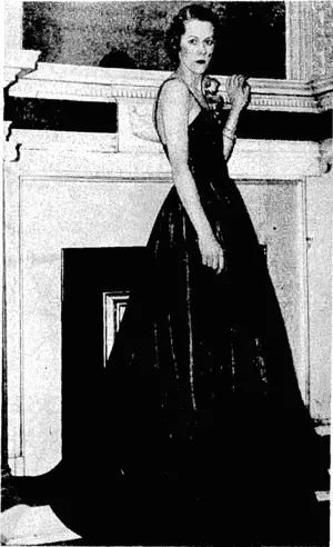 Sportjand General" Photo. "Blue Tulip," a gown in stiff taffeta by Ulrick-Pliilippe, of London. It iscompleted ivith orange poppies on shoulder. (Evening Post, 08 April 1937)