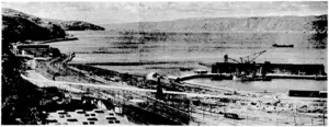livening I'osf t'tioto ■A general view of the waterfront, showing. the ■.. area affected by the new Thorndon overbfidge. The directions: of-'the ramp, already started, is shown by a ivhile line. (Evening Post, 27 April 1937)