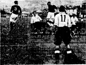 Evenlni Post" Phota* '' Hard-pressed on defence by the Englishmen in the Association game last Saturday, two Wellington men (in black jerseys), Haines on the left and Todd in the centre, jump for the ball. s (Evening Post, 05 June 1937)