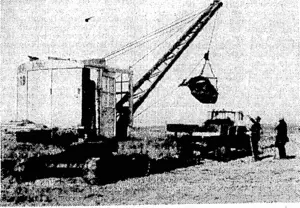 Evoning Post" Photo, A mechanical grab at work on the Whirokino deviation, between Levin and Foxton, which aims to make the main highway between Wellington and Palmerston North safe for motor traffic under flood conditions. (Evening Post, 14 June 1937)