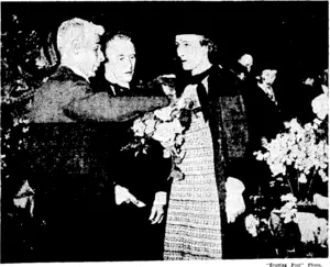 An exhibitor explaining one of the characteristics of a favourite rose to her Excellency Lady Galway at the Wellington Horticultural Society's annual rose show at the Town Hall yesterday. Mr. J. G. MacKenzie, Director of Parks and Reserves, a prominent member of the society, is also interested in the explanation. (Evening Post, 25 November 1937)
