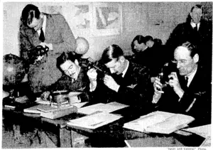 A class receiving instruction in navigation at the "Atlantic" School at Croydon, where pilots who are . (e\operate.4he:mail-and!pas^enger~se^ri^es^tweeriEngland and America receive their training. (Evening Post, 06 January 1938)