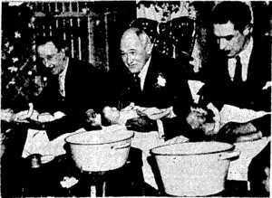 Sport and General" Photo. Fathers taking part in a "bathing-the-baby" competition at a fair held at Romford, England, last month. In the centre is Lieut.-Colonel John Mayhew, M.P., competing against the father of five sets of twins (on left) and his butler,, (on right)* (Evening Post, 13 January 1938)
