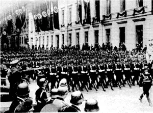 Herr Hitler taking the salute at the inarch past of the Black Guards in the Wilhelhistras.se, Berlin, on April 20, This was one of the principal happenings during the celebrations held to mark -the Fuhrer's .fiftieth birthday. ...■■- (Evening Post, 06 May 1939)