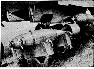 THE BIRTH OF A RAlD—Beneath the bomber the bombs are put on (Rodney and Otamatea Times, Waitemata and Kaipara Gazette, 12 February 1941)