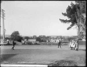 Boys playing with a rugby ball, and girls looking on, Bell Street, Wanganui - Photograph taken by Frank James Denton