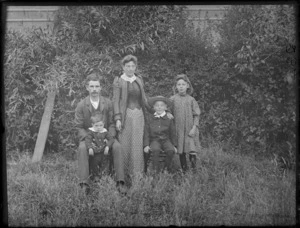 Unidentified couple with their three children, in a garden, probably Christchurch district