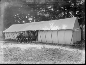 Unidentified group of young men outside a large tent, shows a sign reading 'Tivoli Camp', probably Christchurch district