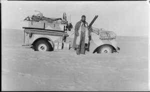 L/Cpl W R Adams alongside bogged Long Range Desert Group truck, Libya