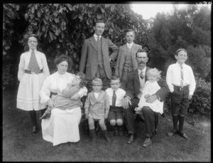 Unidentified couple with eight children, in a garden, probably Christchurch district