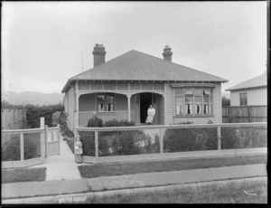 Unidentified woman, man and child in front of house, probably Christchurch district