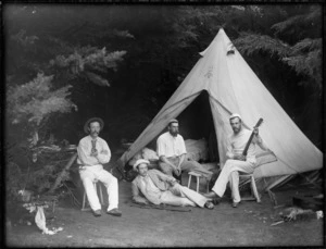 Unidentified men relaxing next to tent at camp site, probably Christchurch district