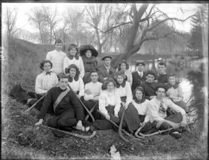 Unidentified group including a hockey team and others, possibly students, probably by the Avon River, Christchurch