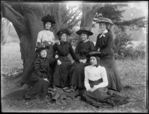 Unidentified women sitting next to tree at park, probably Christchurch district