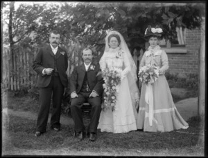 Unidentified bride and groom with best man and bridesmaid, in front of house, probably Christchurch district