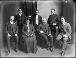 Studio portrait of an unidentified group, with an older couple and five men, some men with handlebar moustaches, Christchurch