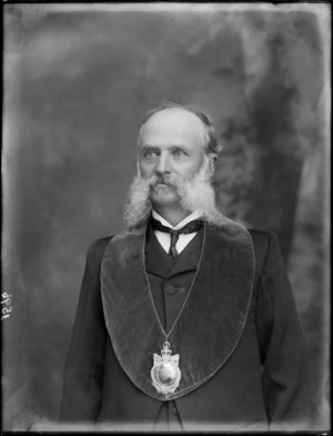 Studio portrait of an unidentified older man with long sideburns and moustache [Hibernian Australasian Catholics Benefit Society member?], wearing a 'collar' and large medallion with crown and inscription, probably Christchurch region