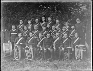 Group portrait of unidentified Salvation Army Brass Band members in uniform, with instruments, bass drum with 'Blood And Fire' motto and 'The Salvation Army' emblem, probably Christchurch region