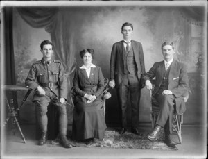 Studio portrait of unidentified family group, probably Christchurch district, showing parents and two sons, one of whom wears an army uniform
