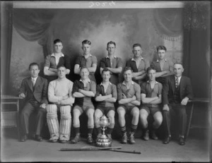 Studio portrait of a men's hockey team with their cup, probably Christchurch region