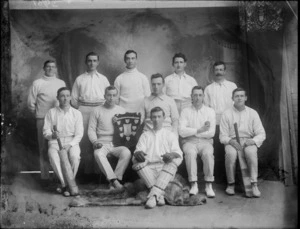 Studio photograph of cricket team with shield, probably Christchurch region