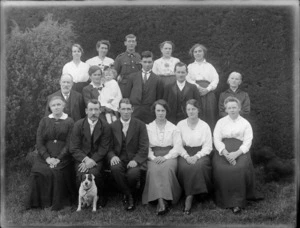 Unidentified group outdoors, probably Christchurch district, includes man in back row wearing army uniform and dog in front