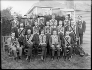 Group of unidentified men from the Hibernian Australasian Catholic Benefit Society, wearing long collars with either stars of flowers on the front, probably Christchurch district