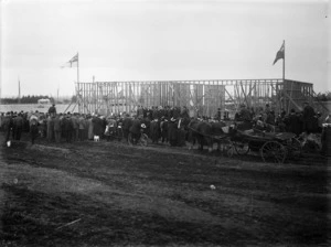 A crowd gathered around the uncompleted structure of the Stratford Technical College for the official laying of the foundation stone