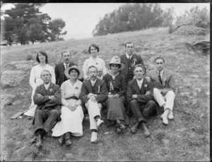 Group of unidentified men and women, each wearing a small rosette pinned to their chest, possibly Christchurch district