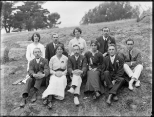 Group of unidentified men and women, each wearing a small rosette pinned to their chest, Christchurch