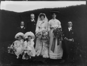 Wedding group, showing unidentified bride, groom, maid of honour, flowergirls, and two other men, possibly Christchurch district