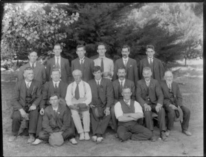 Group of unidentified men, some of whom wear a ribbon on their lapel, all dressed in business attire, possibly Christchurch district