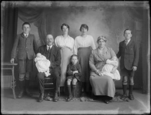Studio portrait of a family group, showing unidentified men, women and children, including two babies, Christchurch