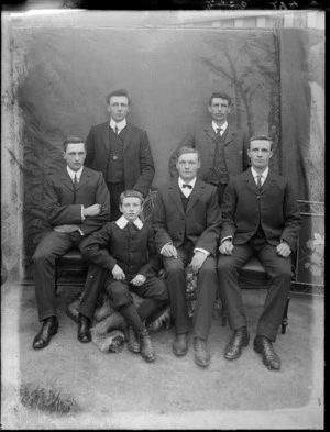 Formal portrait of five men and one boy, all unidentified, with a studio backdrop, possibly Christchurch district