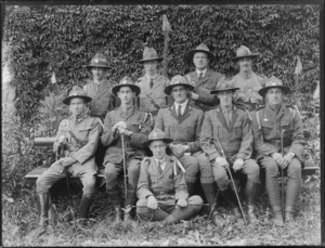 A group of unidentified young men in boy scout uniforms and carrying canes, taken outdoors in an unidentified park, probably Christchurch district