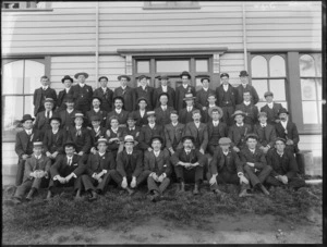 A group of 45 unidentified men standing and sitting in front of a building, probably Christchurch district