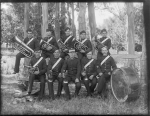 A group of unidentified members of a brass band holding their instruments, taken in an unidentified park, probably Christchurch district