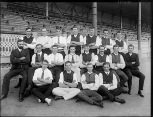 Group portrait of an unidentified Rugby Union Football team, showing members dressed in street clothes, at a sports pavilion, probably Christchurch district