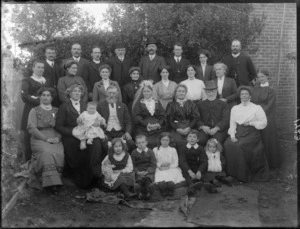 Wedding group, showing unidentified men, women and children, including an elderly bride and groom, in a garden, possibly Christchurch district