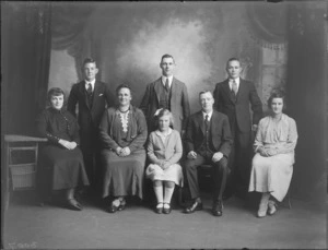 Unidentified family group portrait, four men, three women and a girl, taken in the studio, probably Christchurch district