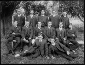 Group of unidentified men dressed in business attire, sitting under a tree at a park, probably Christchurch district