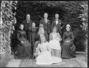 Family group portrait, showing unidentified men and women, outdoors with a dog, possibly Christchurch district