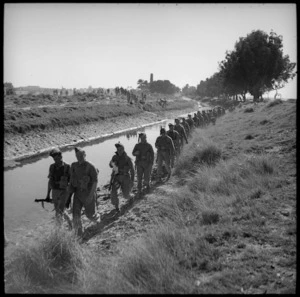 Infantry moving along irrigation canal bank, Egypt