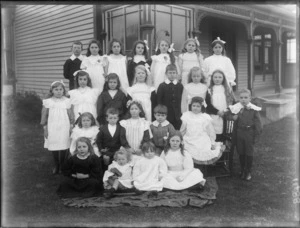 A group of unidentified children, on the lawn in front of the house, possibly Christchurch district