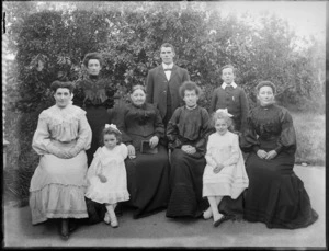 Members of an unidentified family in the garden, showing four women sitting with two girls in the front, a woman, a man and a boy standing behind them, probably Christchurch district