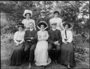Members of an unidentified family, three men and five women, in a park, possibly Christchurch district