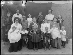Unidentified family group portrait, showing five women with four girls, six boys and two babies, possibly Christchurch district